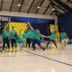 Elementary students perform class dance in green and blue tie-dye shirts