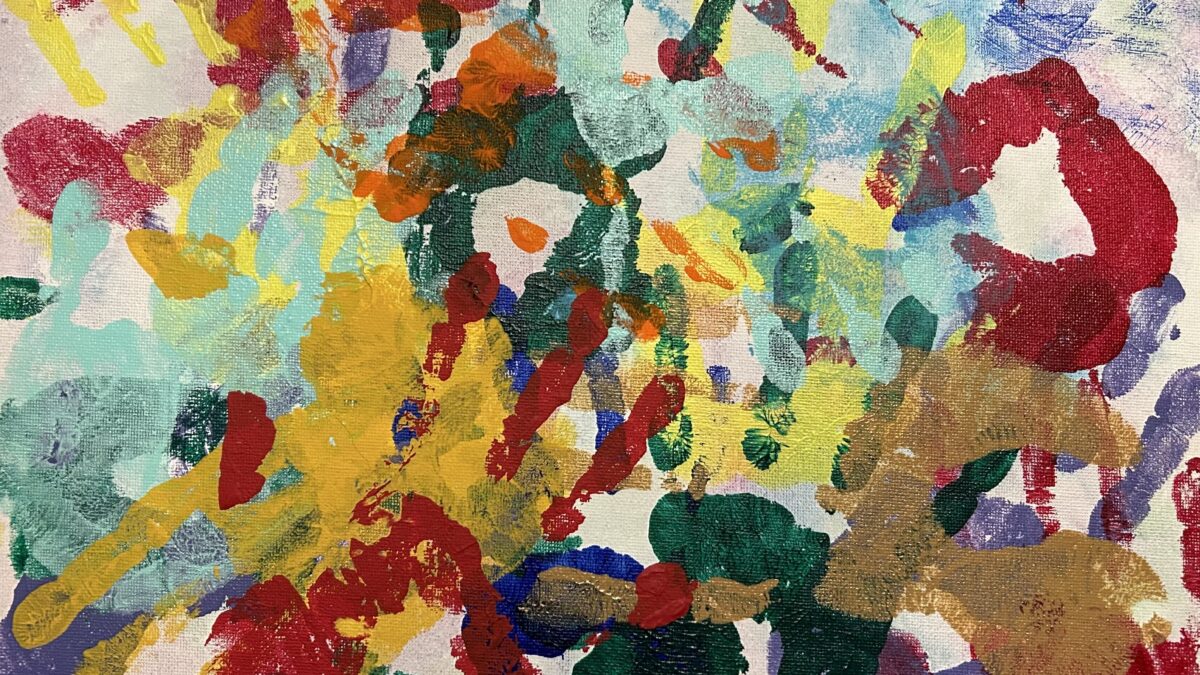 Colorful handprints cover a canvas